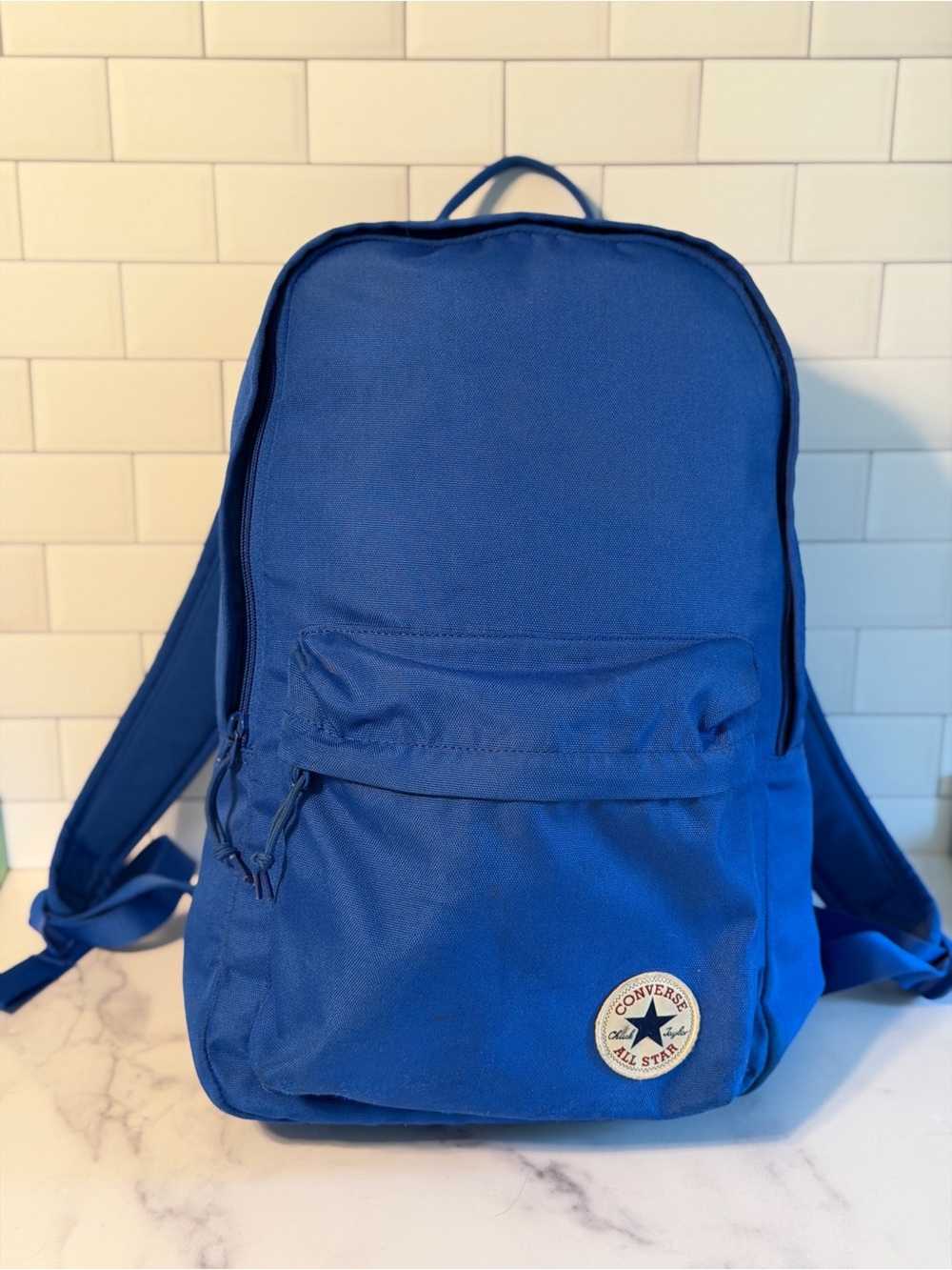 Converse All Star backpack in blue with classic Chuck Taylor logo patch.